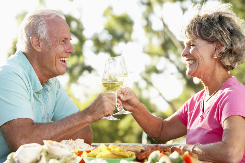 Older couple enjoying breakfast secure that the dentures they received from the menu of restorative dentistry services at Santa Teresa Dental Center.