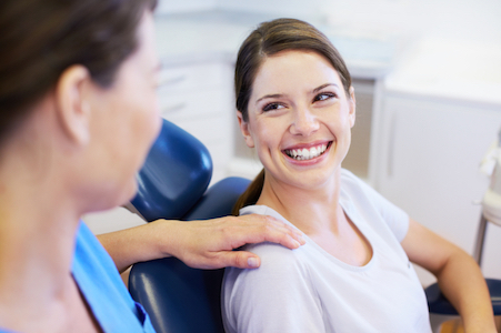 A happy patient smiles at the updated smile she got from the restorative dentistry services received at Santa Teresa Dental Center in San Jose CA.