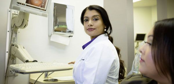 Dr. Lakshmy Sudeep consults with a patient during a general dentistry visit at Santa Teresa Dental Center.