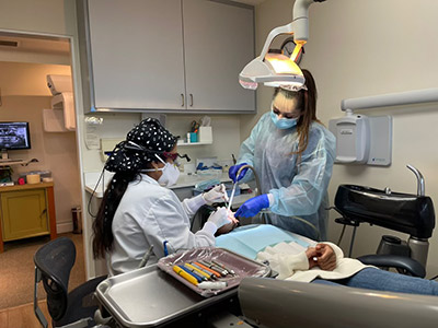 Dr, Lakshmy Sudeep, DDS performing general dentistry on a patient